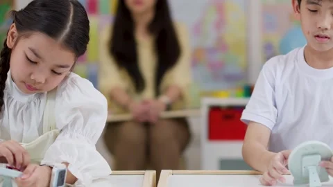 Asian Children Learning Time with Toy Clocks in Classroom Stock Footage 330102116