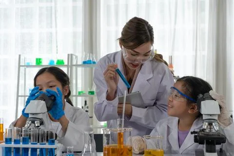 Asian Children Using Microscope to Learn Microbiology and Science in Laborato Stock Photos