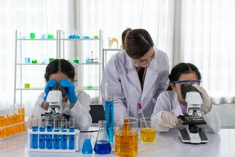 Asian Children Using Microscope to Learn Microbiology and Science in Laborato Stock Photos