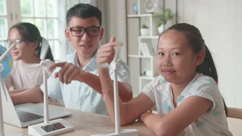 Asian Children Work As A Team Using Laptop Computers To Program Wind Turbines Stock Footage 156426001