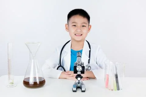 Asian Chinese boy working with microscope Stock Photos