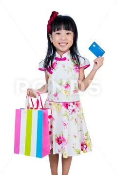 Asian Chinese little girl holding shopping bags with credit card Stock Photos