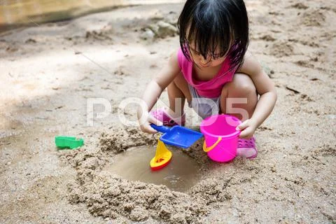 Asian Chinese Little Girl Playing Sand At Creek