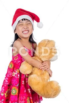 Asian Chinese little girl wearing santa hat on isolated white Stock Photos