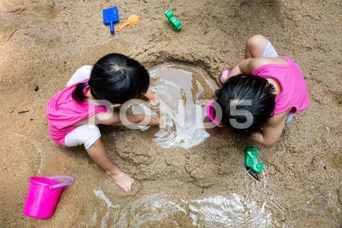 Asian Chinese Little Sister Playing Sand At Creek