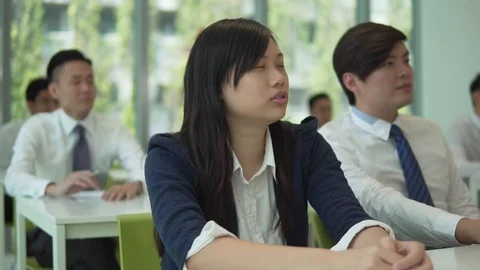 Asian Chinese students in corporate classroom setting Stock Footage