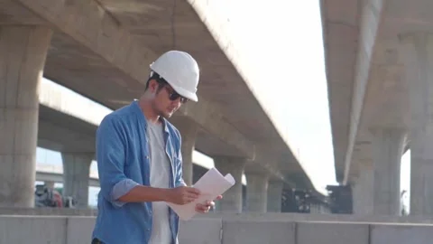Asian civil engineer is inspecting construction project a road .expressway .. Video stock 244196295