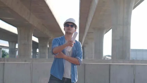 Asian civil engineer is inspecting construction project a road .expressway .. Video stock 244196330