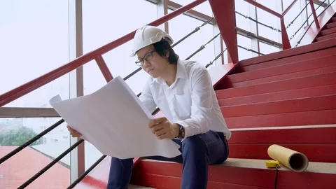 Asian civil engineer man checking architectural drawing at site Stock-Footage 90637557