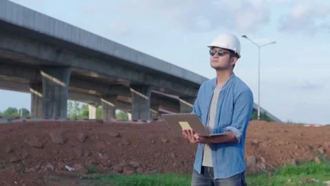 Asian civil engineer using laptop is inspecting construction project a road.. Video stock 244196523