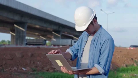 Asian civil engineer using laptop is inspecting construction project a road.. Video stock 244196964