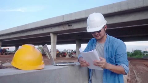Asian civil engineer using laptop and blueprint is inspecting construction .. Stock-Footage 244196965