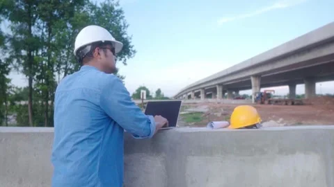 Asian civil engineer using laptop is inspecting construction project a road.. Stock-Footage 244198879