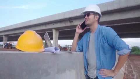 Asian civil engineer using phone and laptop  inspecting construction projec.. Video stock 244196963