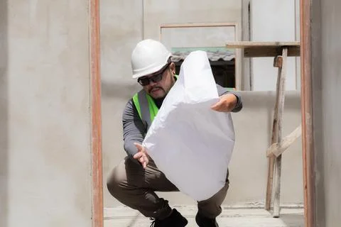 Asian construction project foreman with beard inspects construction site ho.. Stock Photos