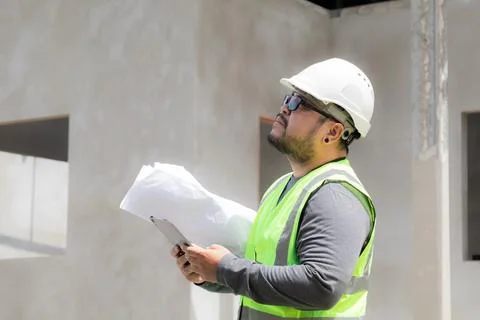 Asian construction project foreman with beard inspects construction site ho.. Stock Photos