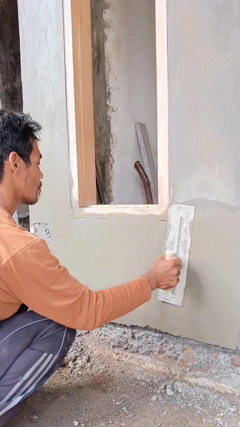 Asian construction worker smoothing wet cement Stock Footage 335018995