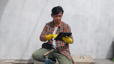 Asian constructor worker man with tablet computer smiling looking at camera Stock Footage 268685179