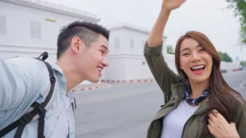 Asian couple backpacker use mobile phone selfie, take picture in city. Video stock 171262916