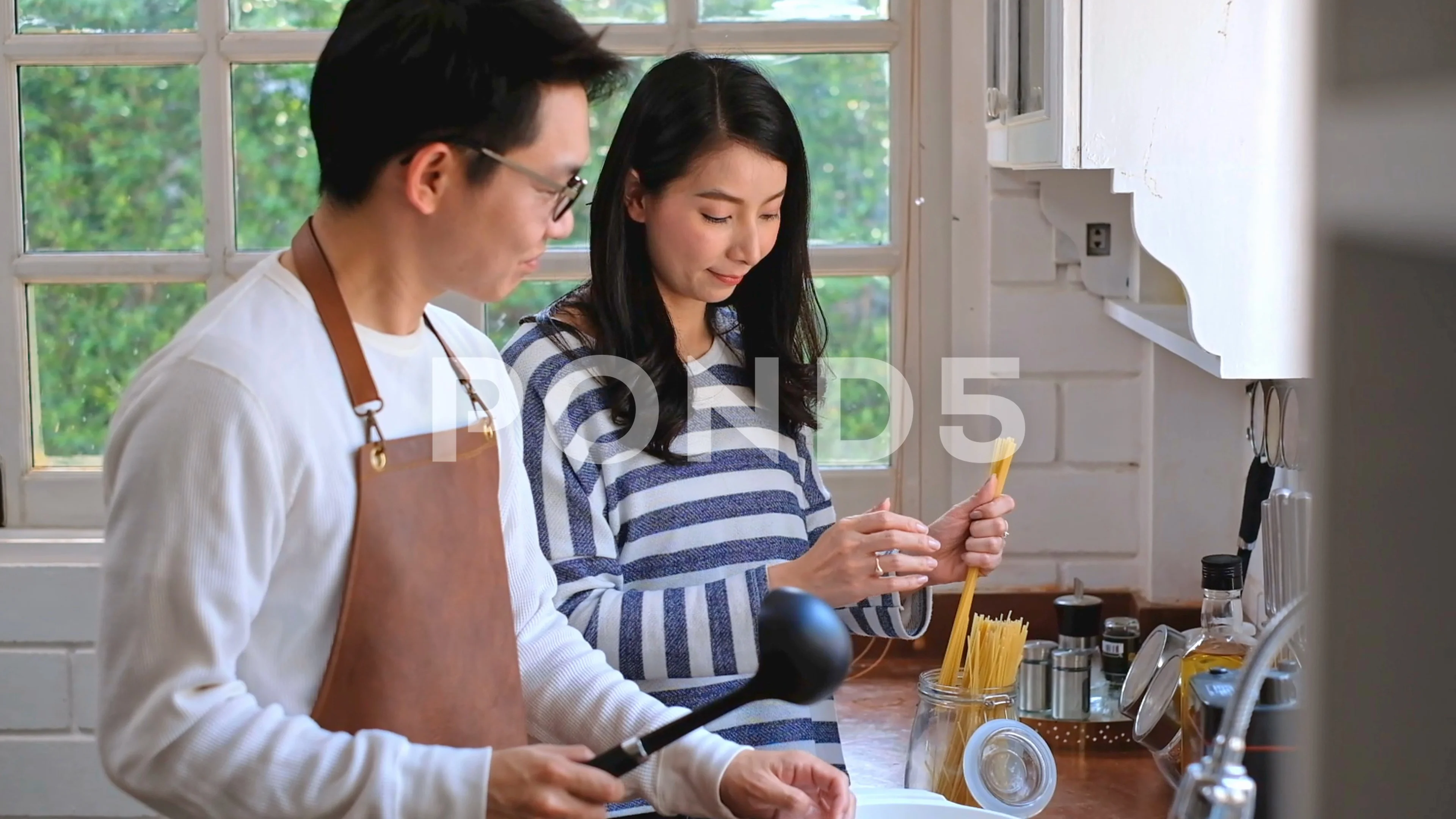Asian family is cooking in the kitchen together