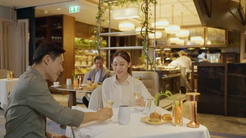 Asian couple having dinner at an upscale restaurant. Stock Footage 198907195