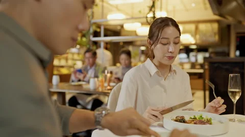 Asian couple having dinner at an upscale restaurant. Stock Footage 198907422