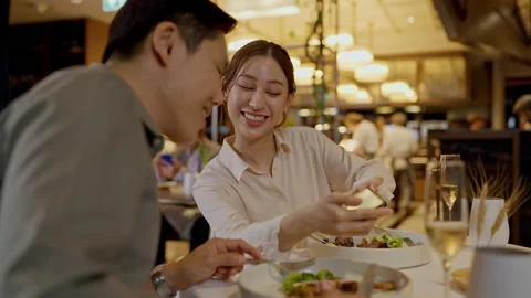 Asian couple having dinner at an upscale restaurant. Stock Footage 200999891