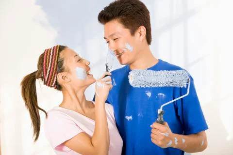 Asian couple painting and being playful Stock Photos