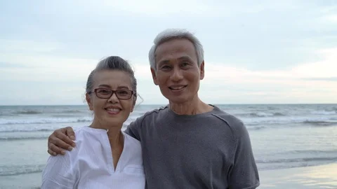 Asian couple senior elder looking camera closeup sunset Видео 115879958
