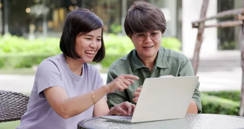 Asian couple two women using laptop and smartphone for online business working Stock Footage 163661022