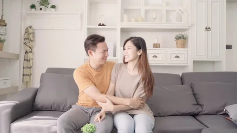 Asian couple using smartphone check social media in living room at home. Stock Footage 98711149