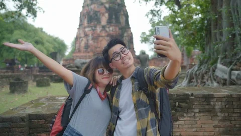 Asian couple using smartphone taking selfie at Ayutthaya, Thailand. Stock Footage 103503985