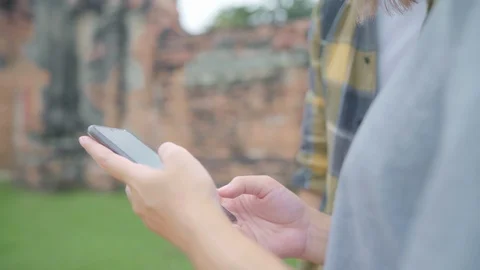 Asian couple using smartphone while holiday trip at Ayutthaya, Thailand. Stock Footage 103505996
