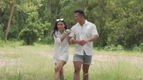 Asian couple young man and woman walking travel in forest happy romantic outdoor Stock Footage 143457448