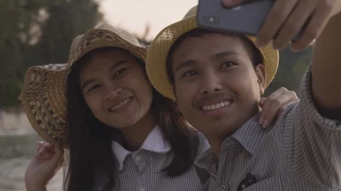 Asian couples are posing together with smartphones at the seaside. Stock Footage 100939884
