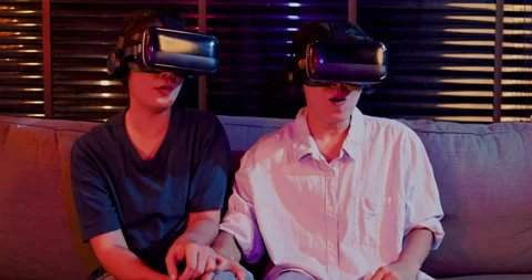 Asian couples wearing modern Virtual reality glasses sit and watch movies Stock Footage 164659863