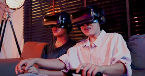 Asian couples wearing modern Virtual reality glasses sit and watch movies Stockbeeldmateriaal 164660423