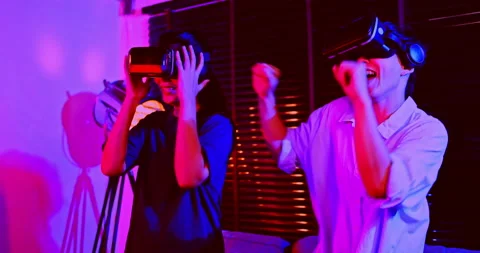 Asian couples wearing modern Virtual reality glasses sit and watch movies Stock Footage 172103502