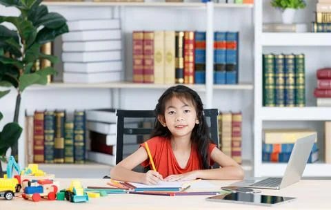 Asian creative young primary school girl artist in casual outfit sitting us.. Stock Photos