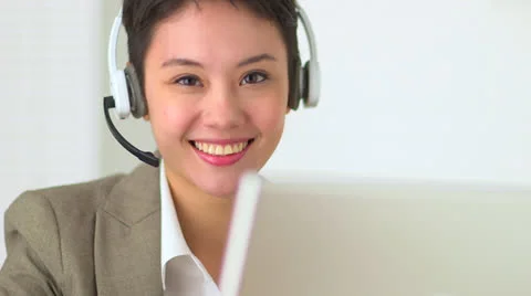 Asian customer service representative with headset in call center 스톡 동영상 22635115