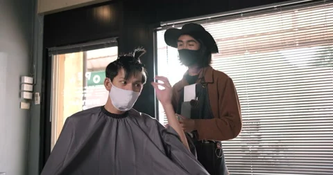 Asian customer talking with barber in barber shop Hair cutting wearing face mask Stock-Footage 135569005