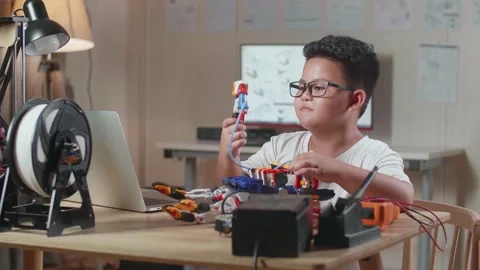 Asian Cute Boy With A Laptop Checking A Cyborg Hand At Home Stock Footage 212017848