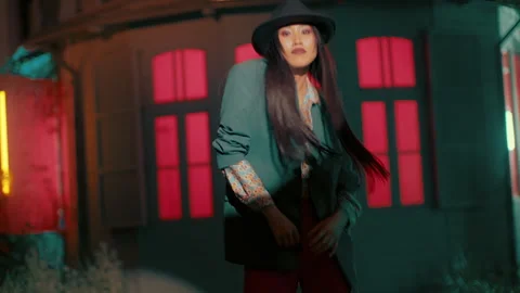 Asian Dancer with a hat in front of a funky house Stock Footage 274944023