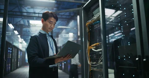 Asian Data Center Engineer Using Laptop Computer Stock Footage 319995767