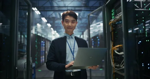 Asian Data Center Engineer Using Laptop Computer Stock Footage 319998997