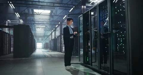 Asian Data Center Engineer Using Tablet Computer Stock Footage 320000896