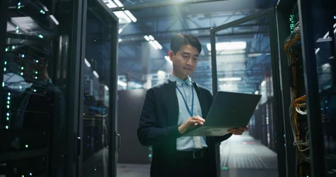 Asian Data Center Engineer Using Laptop Computer Stock Footage 320001789