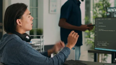 Asian database programer writing code on computer Stock Footage 231448752