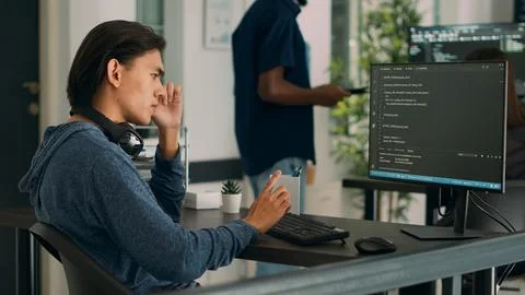 Asian database programer writing code on computer Foto stock