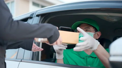 Asian delivery man send a package to customer on the cargo car. Video stock 213592700